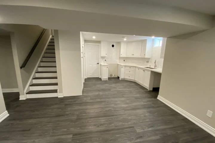 Finished basement living space and white kitchenette