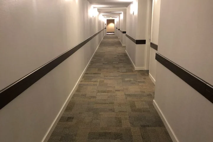 Finished corridor with carpet and wall rails