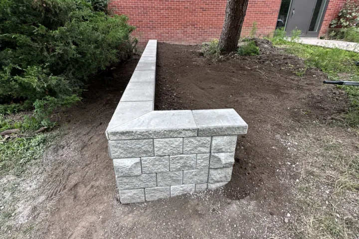 Finished masonry planter beside the building