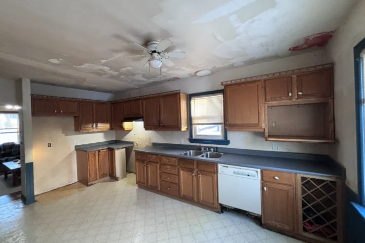 Original kitchen with wooden cabinetry and tiled floor