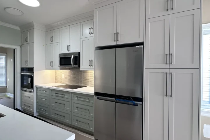Completed kitchen cabinetry and stainless refrigerator