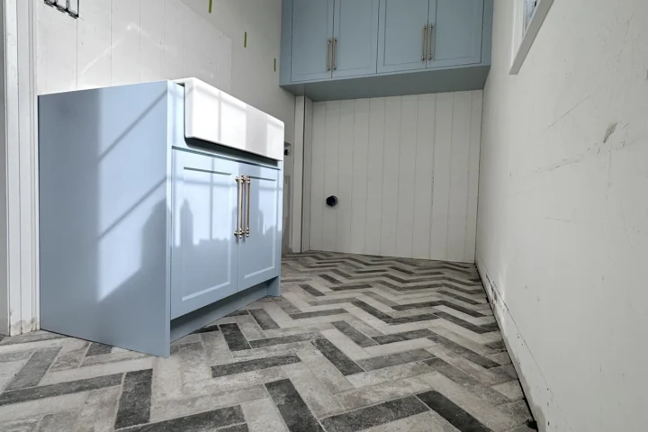 Finished laundry cabinetry and patterned floor