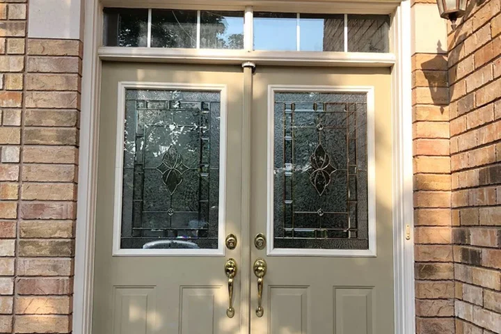 Original double entry doors beneath an arched window